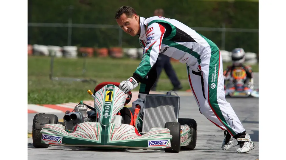 Michael Schumacher pushing his kart down the South Garda Karting track in Italy in 2009. This image is for reference purposes only.