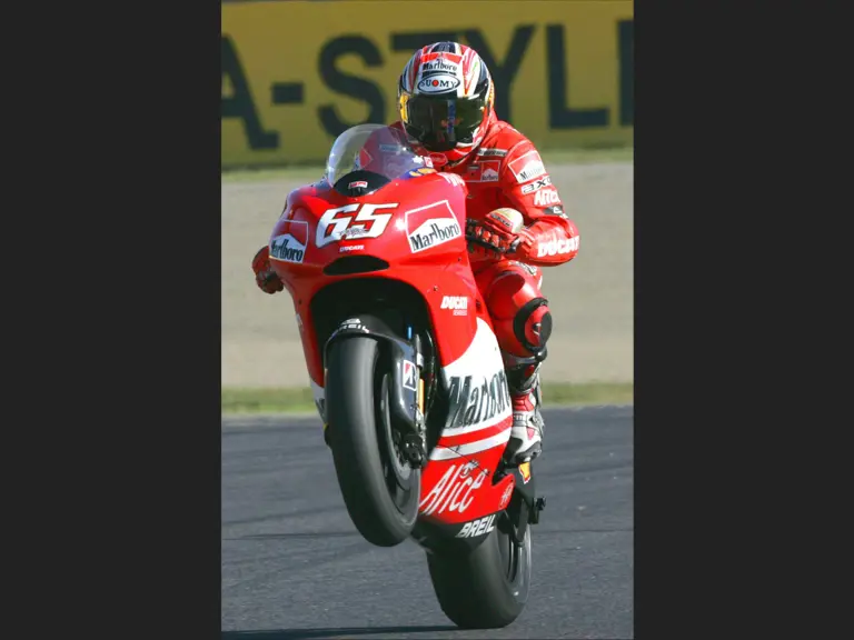 Loris Capirossi does a wheelie as he approaches the finish line during the 2006 Grand Prix of Japan.