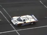 The 962 hurtles along the start-finish line at the 1986 24 Hours of Le Mans.