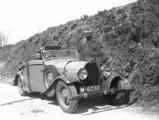 A gentleman stops to have his photograph taken in this Bugatti Type 49, circa late 1940s.