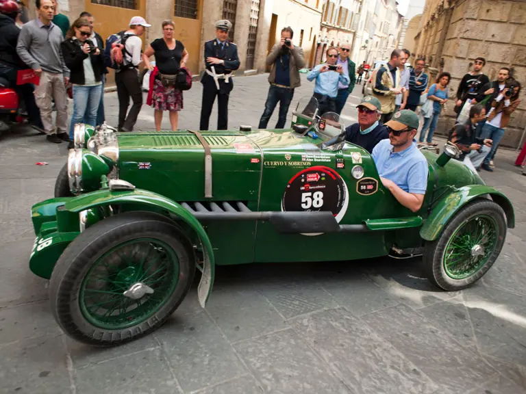 Crowds line the streets for the 2012 Mille Miglia Storica. The MG is pictured driving through the medieval city of Siena.