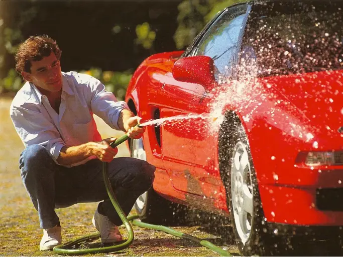 Ayrton Senna is pictured washing the NSX in a timeless shot.