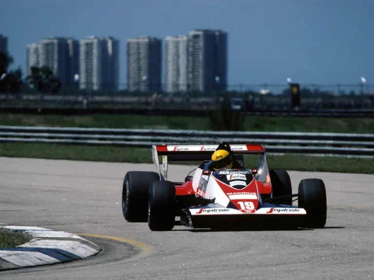 The Rio de Janeiro cityscape provides the backdrop as Senna heads for another apex.