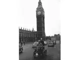 The De Dion trike passes Big Ben on the approach to Westminster Bridge in a 1960s edition of the London to Brighton Veteran Car Run.
