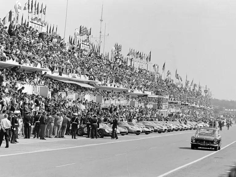 The Ferrari is captured driving along the grid prior to the start of the 1963 24 Hours of Le Mans.