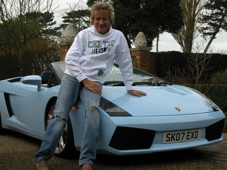 Rod Stewart poses with his Lamborghini Gallardo Spyder outside his home in 2009.