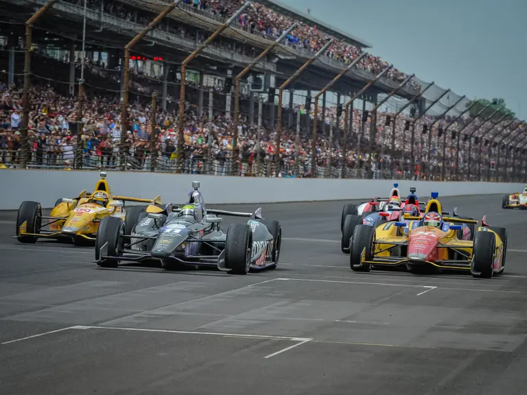 Tony Kanaan victoriously crosses the finish line at the 2013 Indianapolis 500.