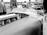 Carroll Shelby grins at the sweet sounds being made by his Ferrari, chassis no. 0478 AM (#103), in the paddock before the start of the feature race at the 31 July 1955 SCCA Nationals held at Bremerton, Washington.