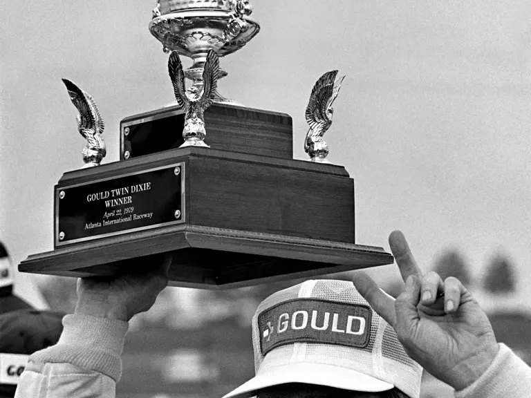 Johnny Rutherford celebrates winning the Gould Twin Dixie 125 at the Atlanta International Raceway.