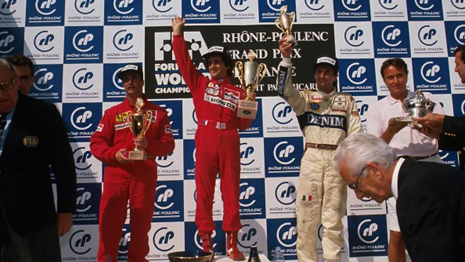 Nigel Mansell stands on the podium with Alain Prost and Riccardo Patrese after finishing 2nd at the 1989 French Grand Prix.