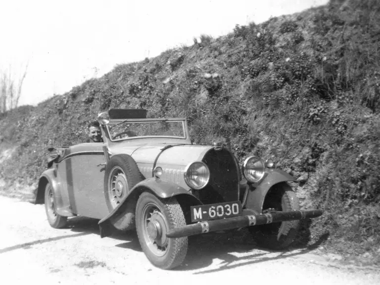 A gentleman stops to have his photograph taken in this Bugatti Type 49, circa late 1940s.