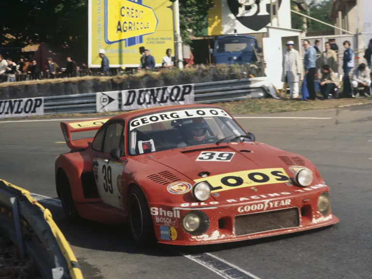 The Georg Loos Porsche 935 #39, driven by Toine Hezemans, Tim Schenken, and Hans Heyer, rounds a corner at the 1977 24 Hours Le Mans.