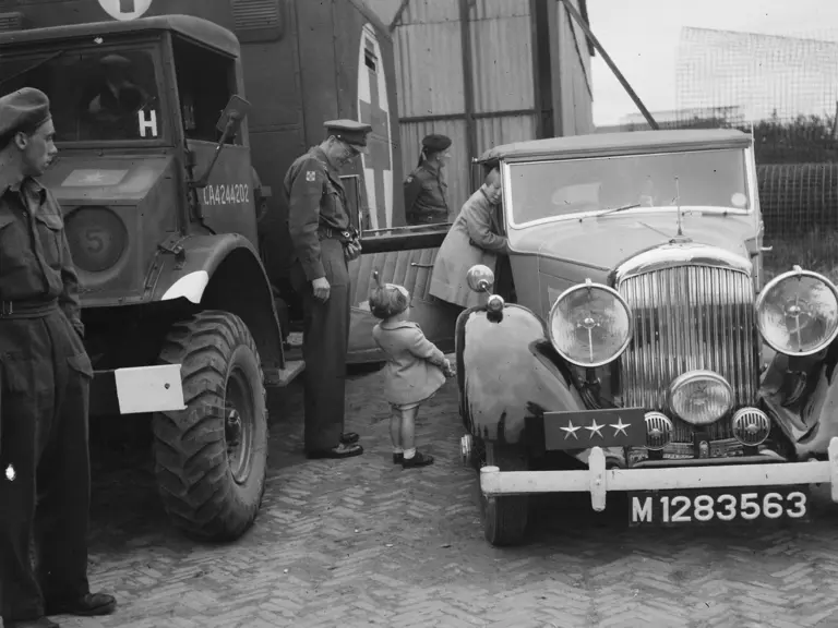 Prince Bernhard waits with the Bentley as Princess Juliana returns from Canada to the liberated Netherlands in August 1945.