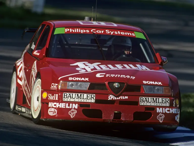 The Alfa Romeo 155 TI touring car tackles the kerbs at the Hockenheimring during the 1994 DTM season.