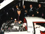 Claudio Zampolli displaying the engine compartment of the Cizeta-Moroder V16T at the 1989 Geneva Auto Salon.