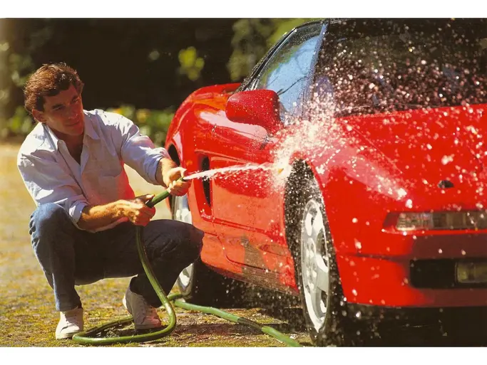 Ayrton Senna is pictured washing the NSX in a timeless shot.