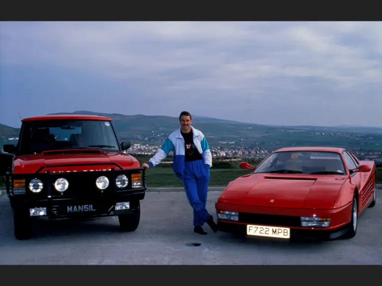 Nigel Mansell is pictured with his Ferrari Testarossa, presented to the driver while racing for Scuderia Ferrari.